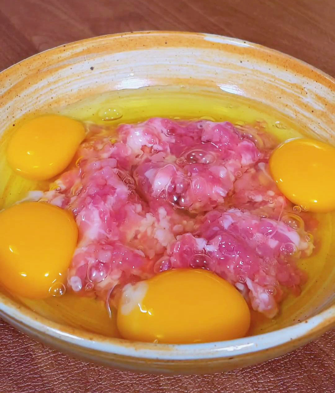Crack 4 eggs into a bowl with the minced pork