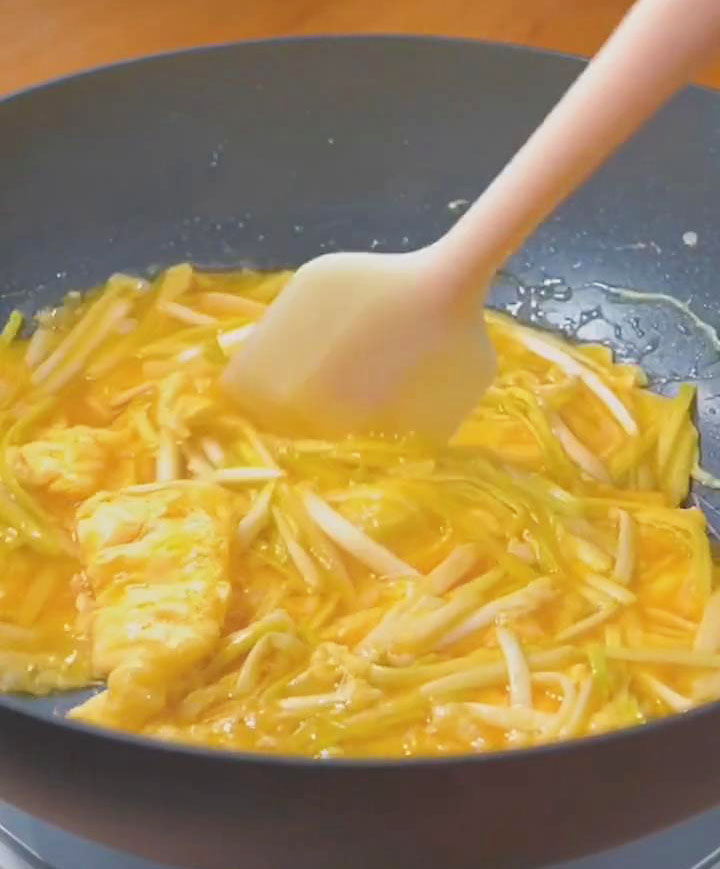 Gently push the edges of the egg mixture with a spatula