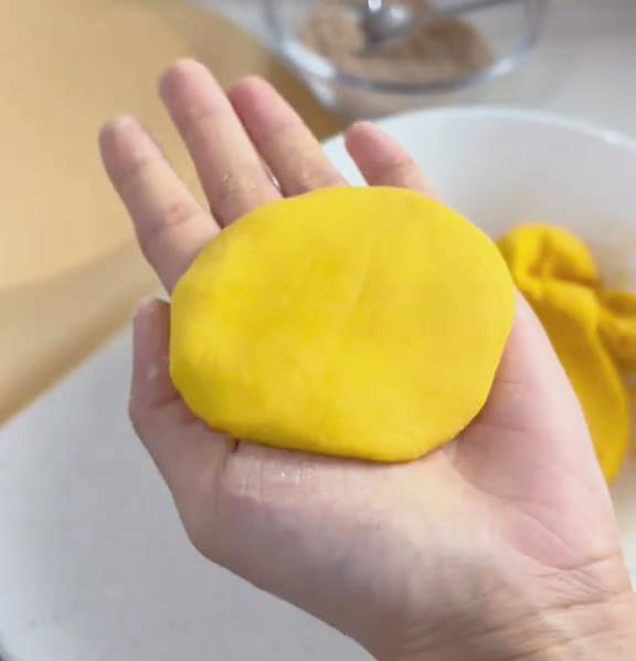 Press the cake gently with both hands to flatten it slightly