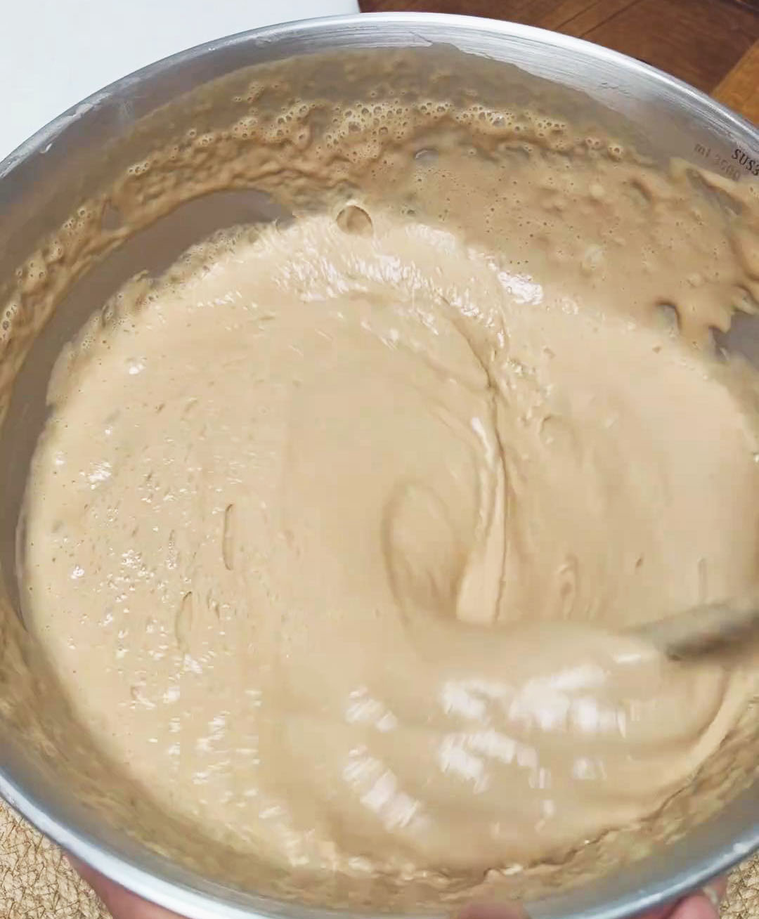 Once the batter has risen, stir it to release any trapped air