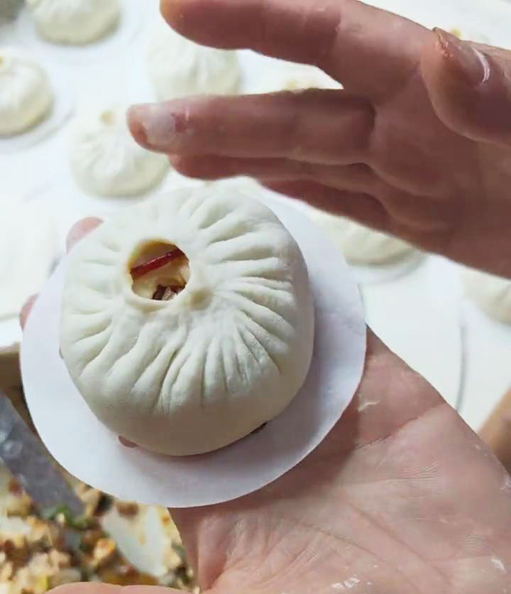 Place the shaped buns on the parchment paper