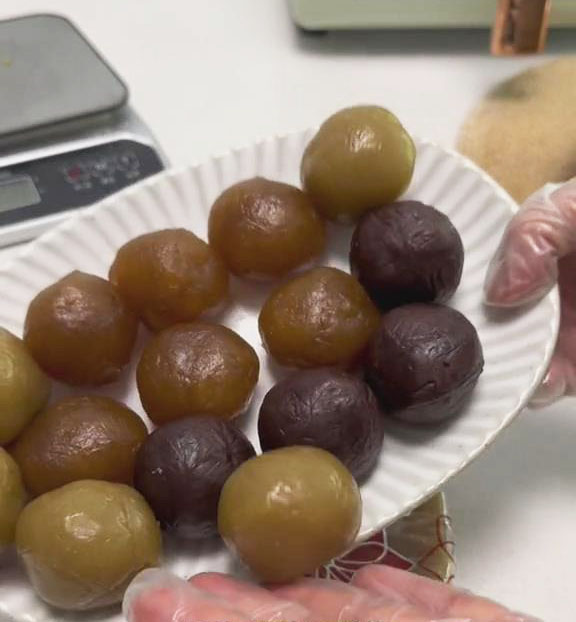 Weigh out 45g of filling for each mooncake, rolling each portion into a ball and setting aside