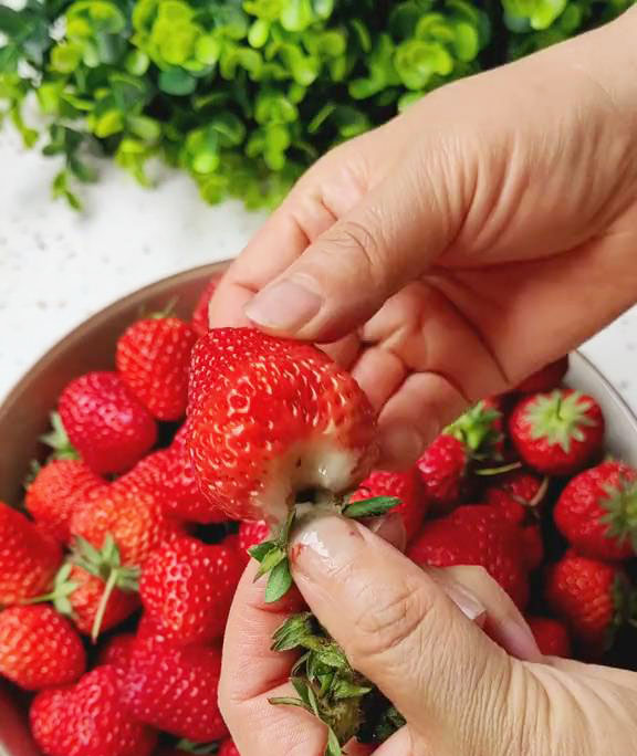 Wash and hull the strawberries, removing the green tops