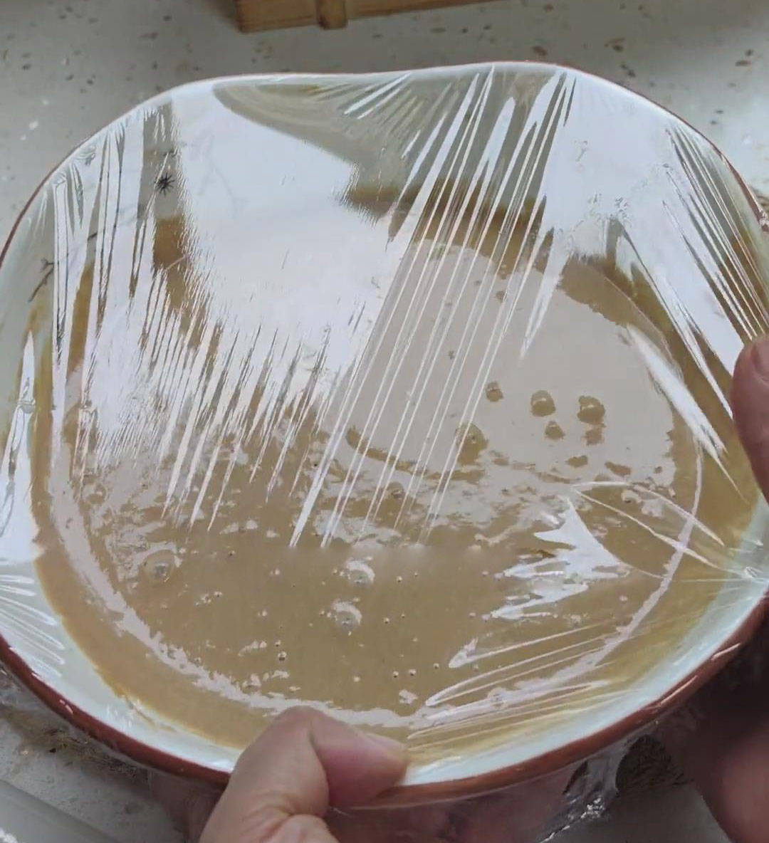 cover the container with plastic wrap