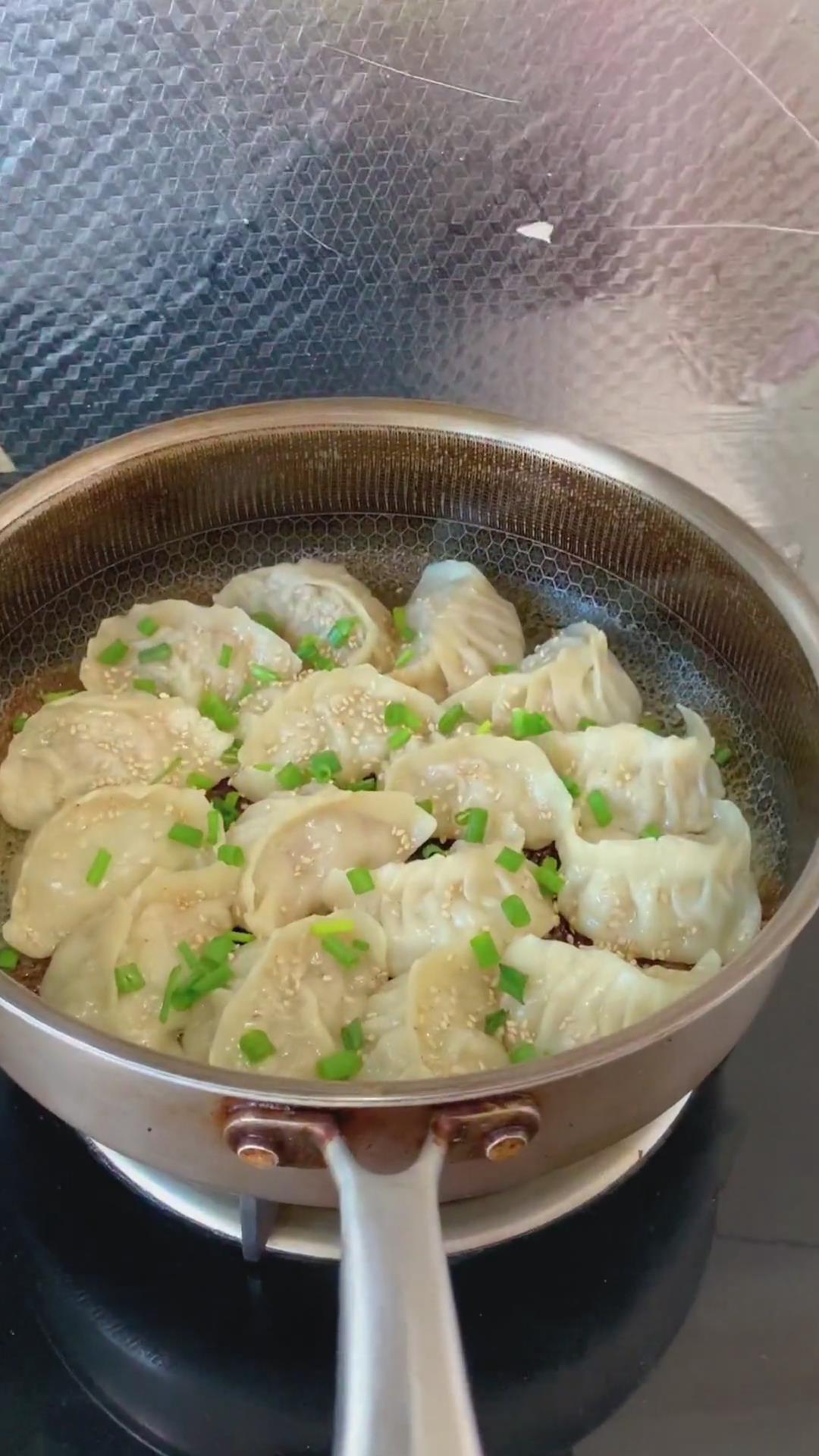 sprinkle toasted sesame and chopped green onions over the dumplings