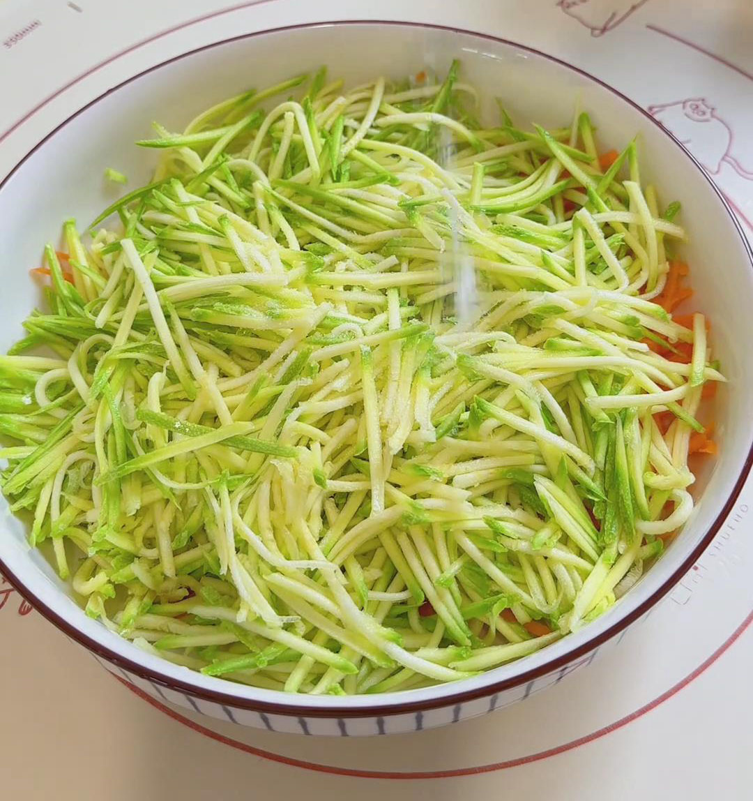 Place both grated vegetables in a large bowl Place both grated vegetables in a large bowl