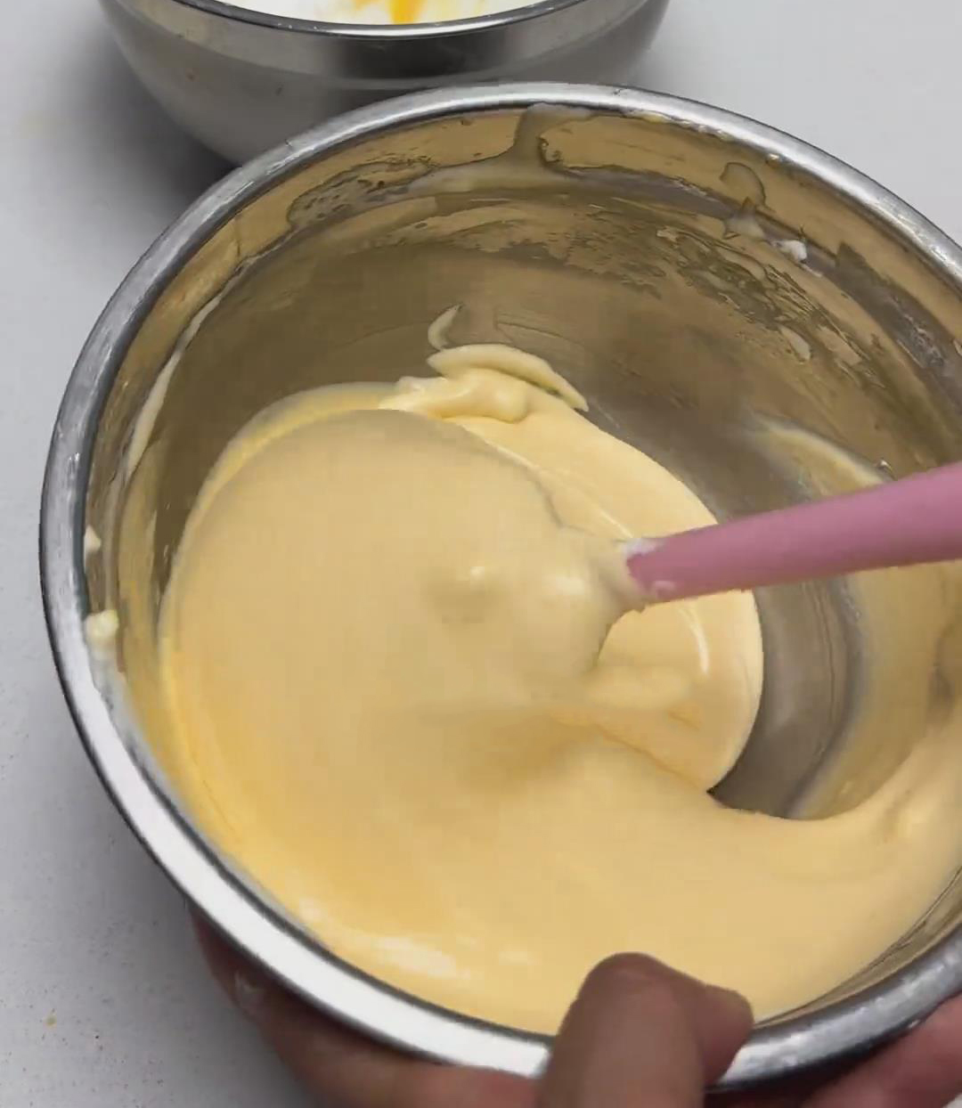 Add one-third of the meringue to the yolk batter Add one third of the meringue to the yolk batter
