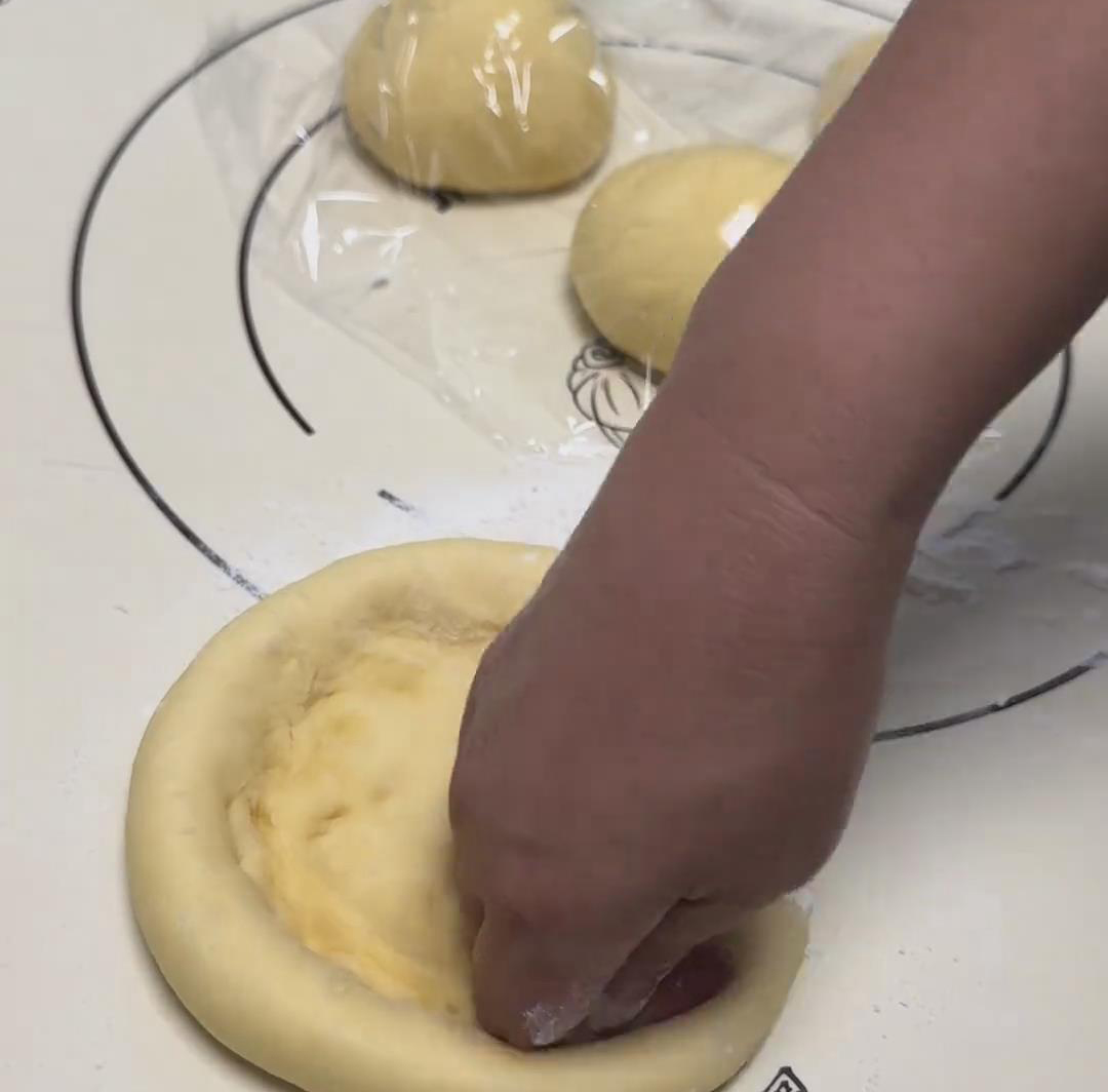 Flatten one dough ball into a round disc with your palm Flatten one dough ball into a round disc with your palm