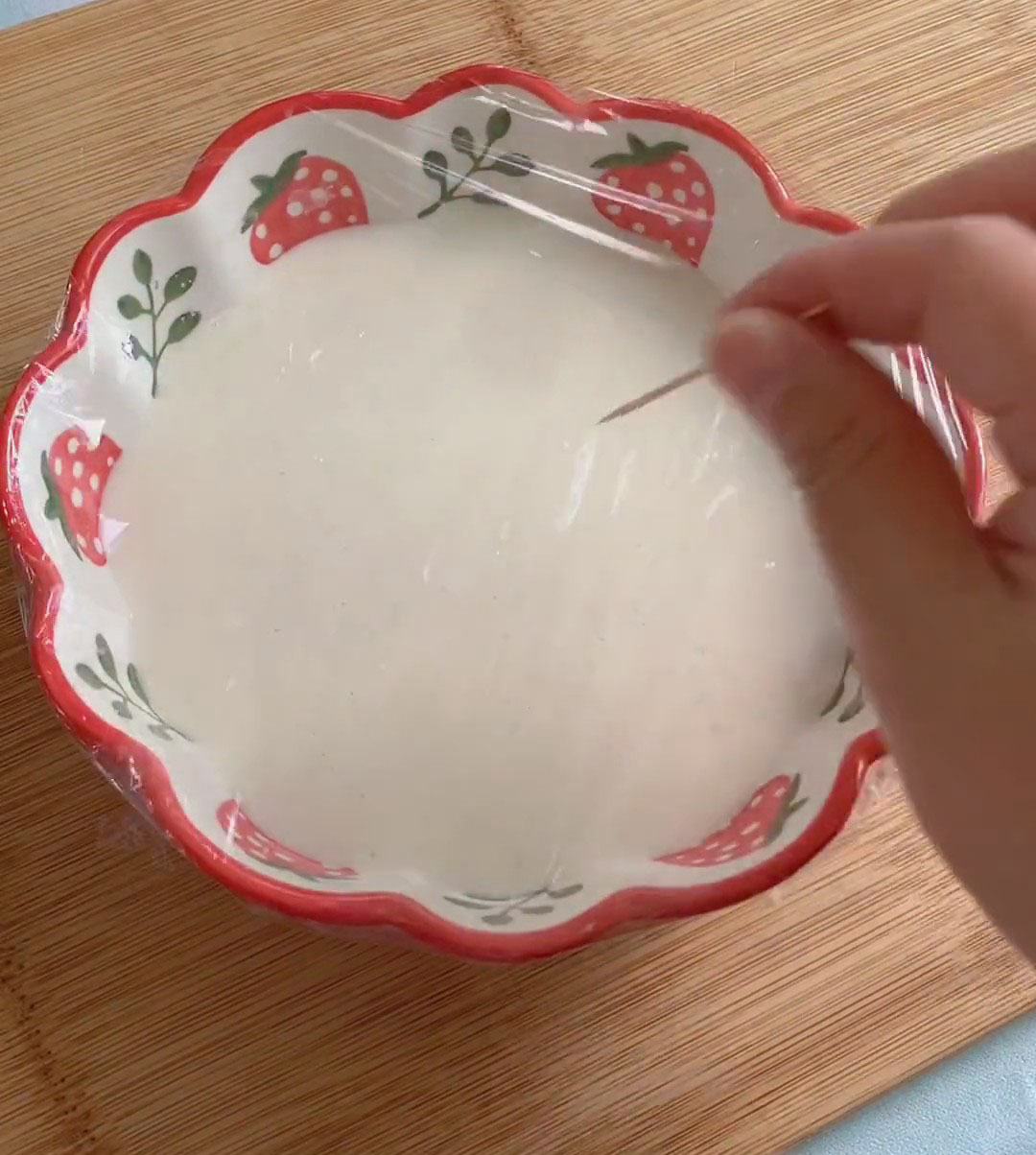 Cover the bowl with plastic wrap and poke a few small holes