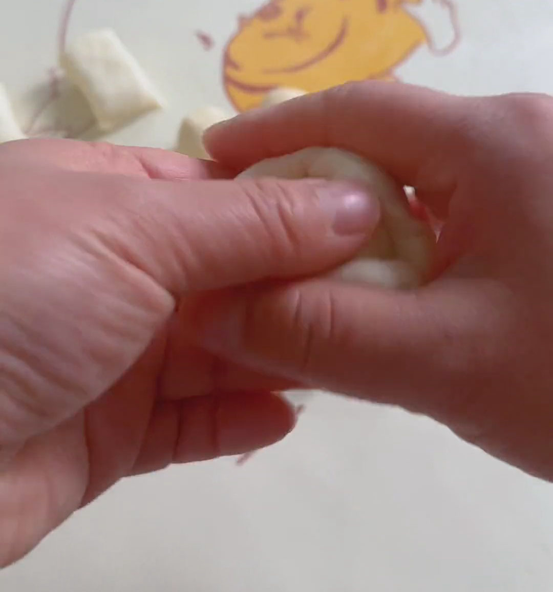 Gather the edges of the water oil dough toward the middle and pinch tightly to seal