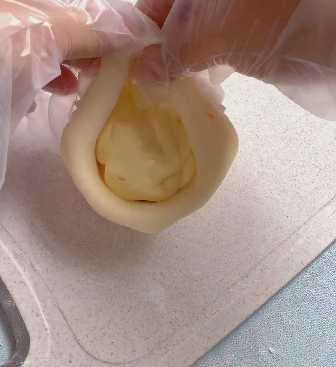 Gather the edges toward the center and pinch tightly to seal