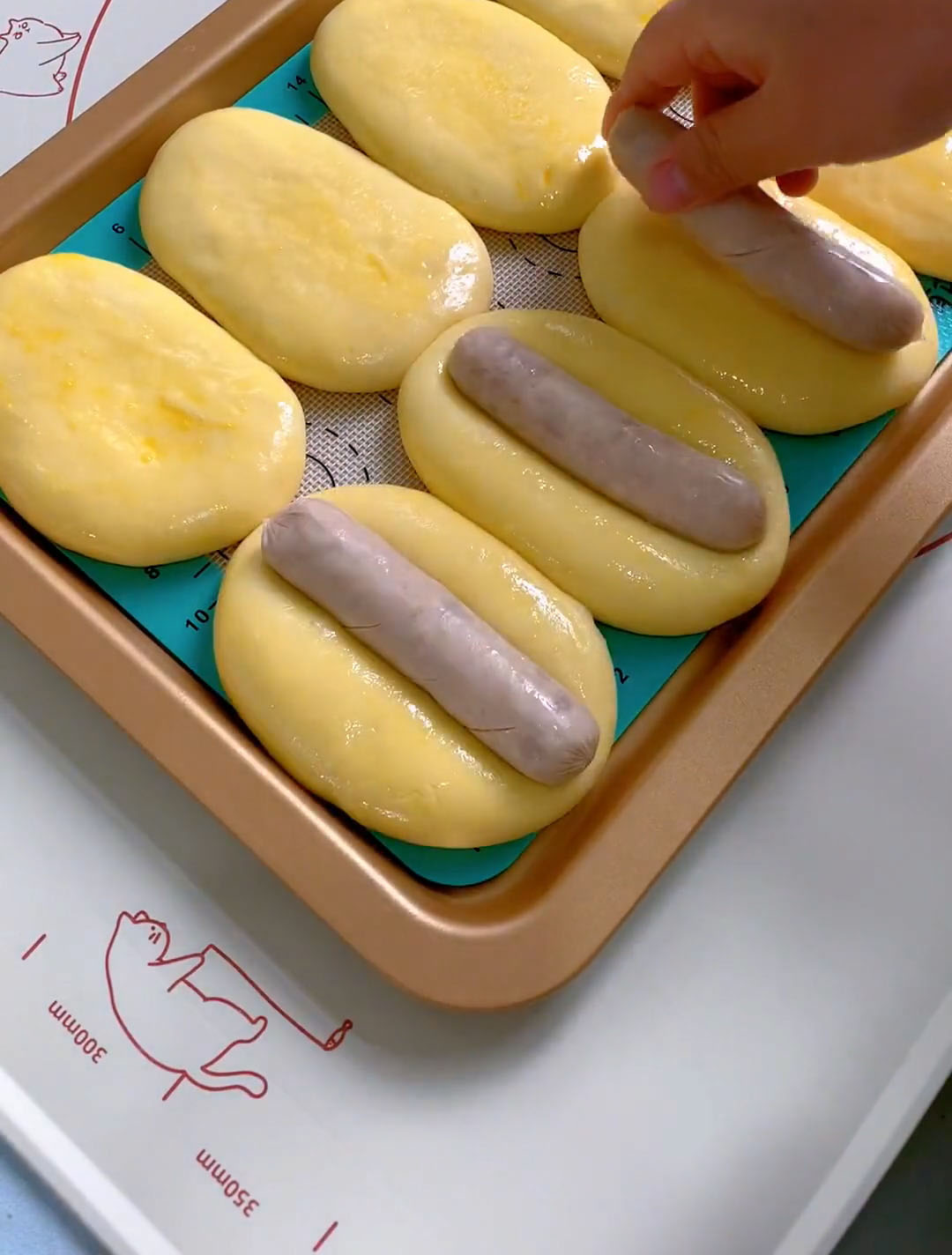 Place one hot dog in the center of each bun,