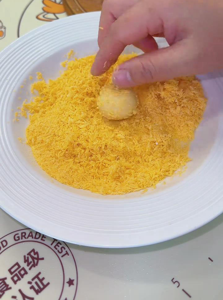 Place the balls into the breadcrumbs and roll them until evenly coated