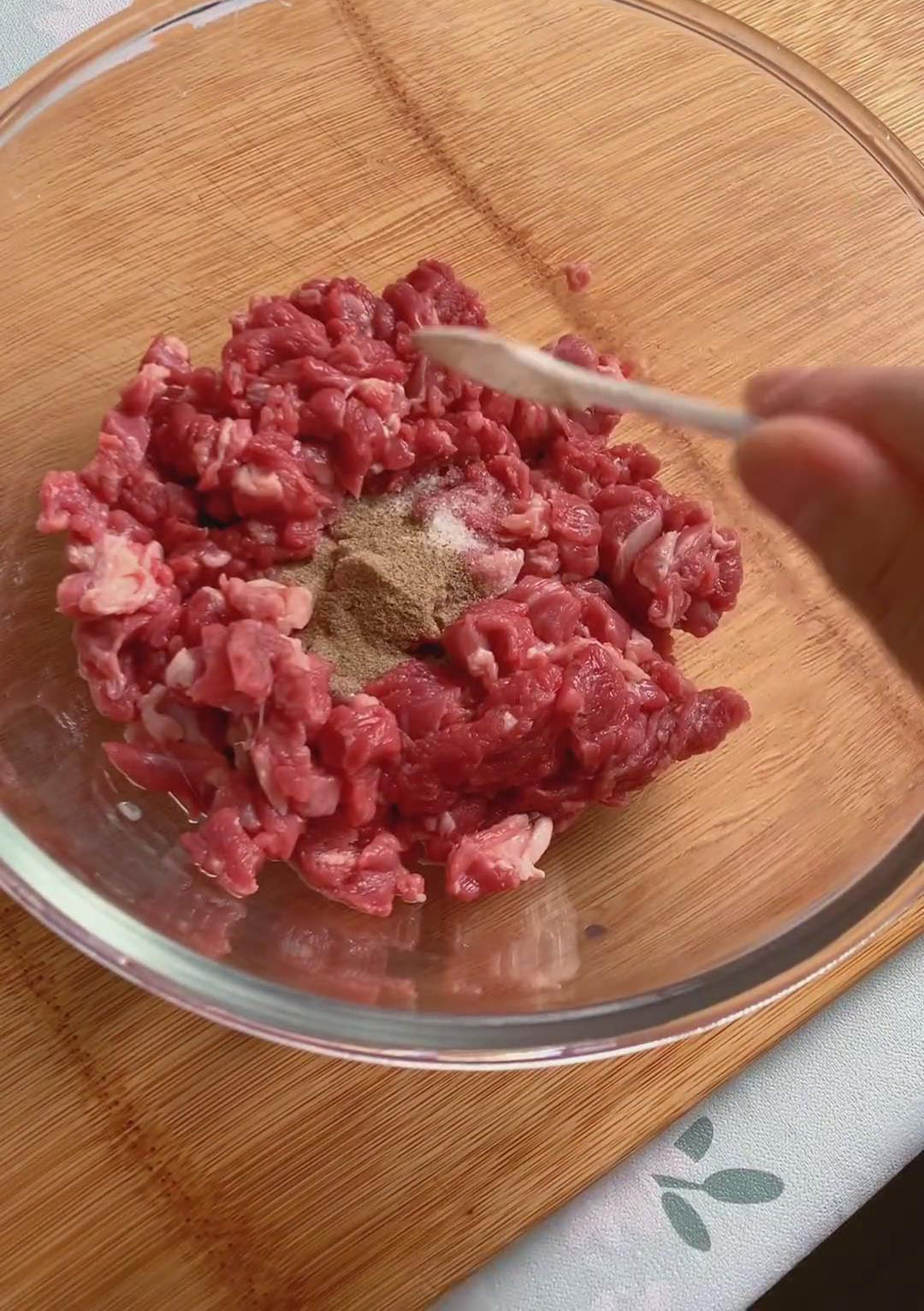 Place the beef in a bowl and add salt, freshly ground black pepper, and ground cumin