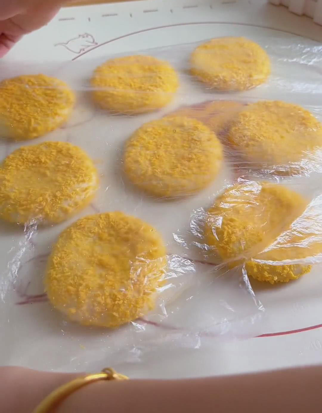 Place the coated buns on a board, cover with plastic wrap Place the coated buns on a board, cover with plastic wrap