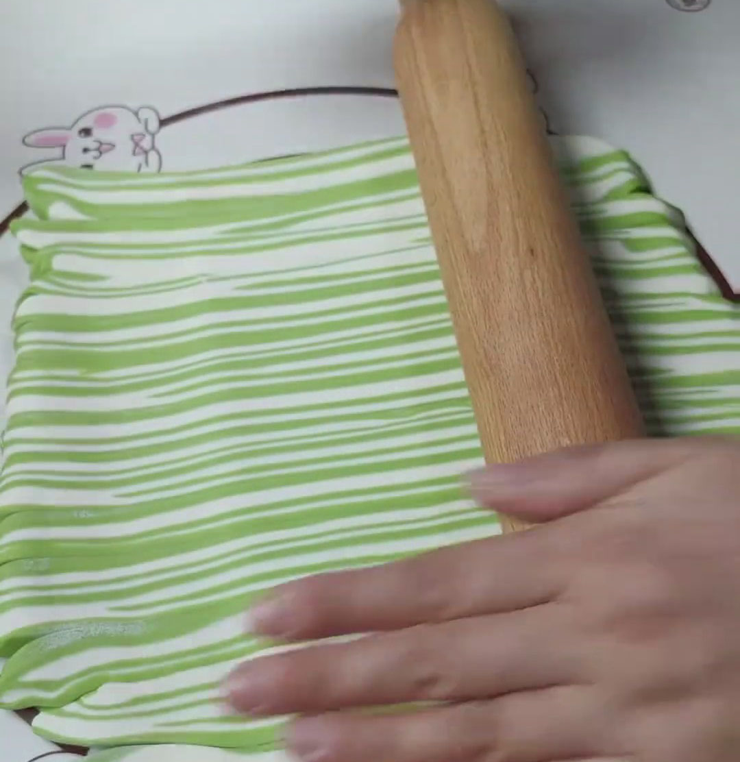 Roll the dough into a thin sheet once more Roll the dough into a thin sheet once more