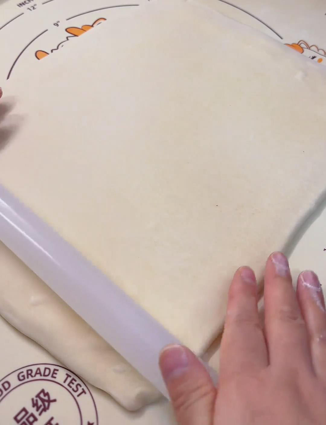 Roll the laminated dough into a large, even sheet. Roll the laminated dough into a large, even sheet.
