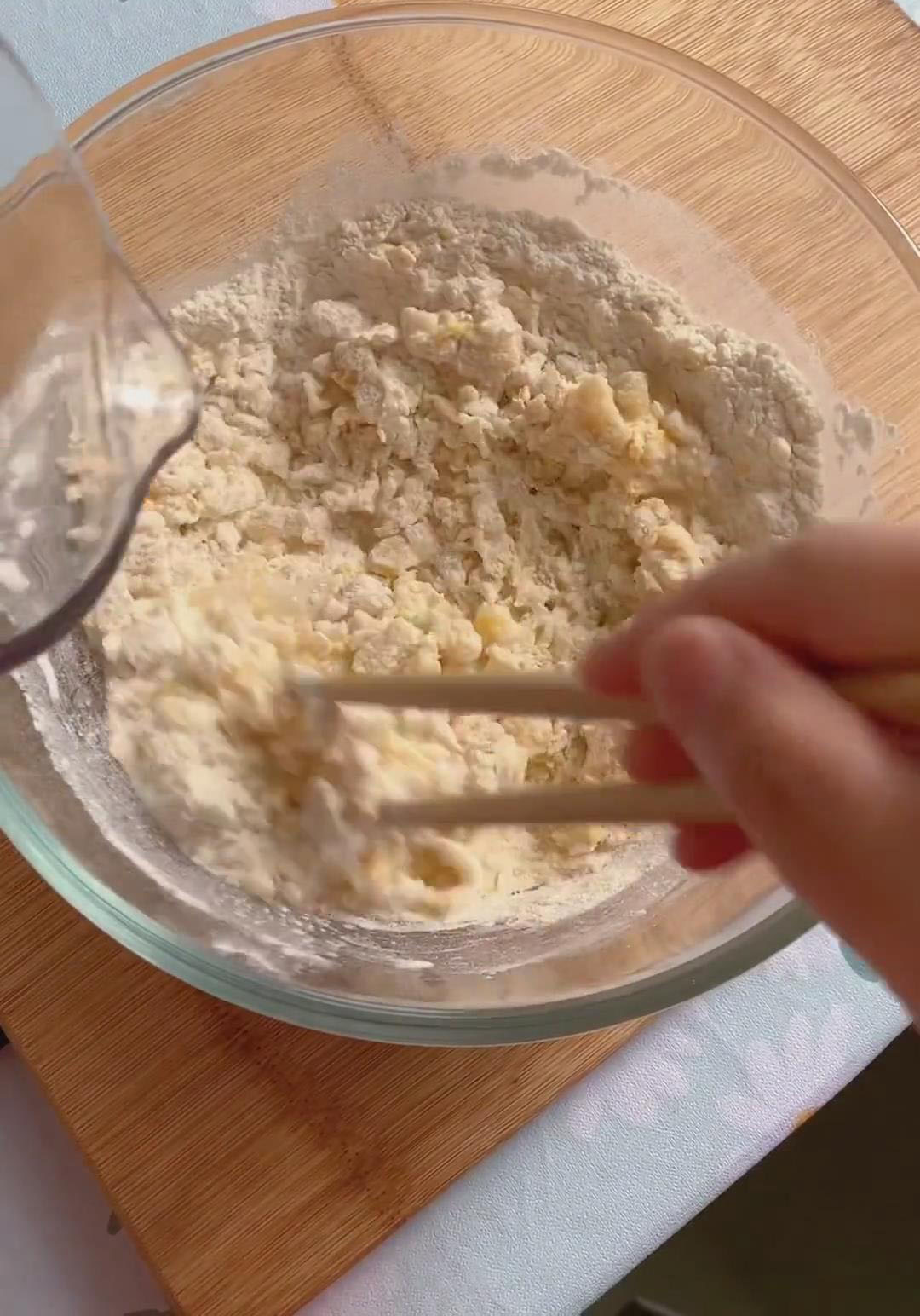 Slowly add the warm water while stirring with chopsticks