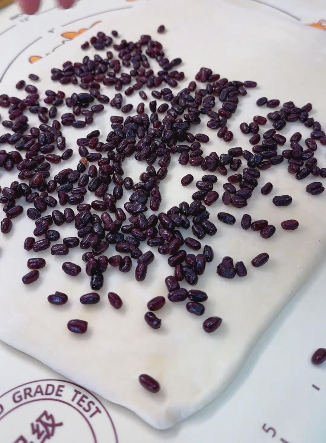 Sprinkle sweet red beans evenly over two thirds of the surface