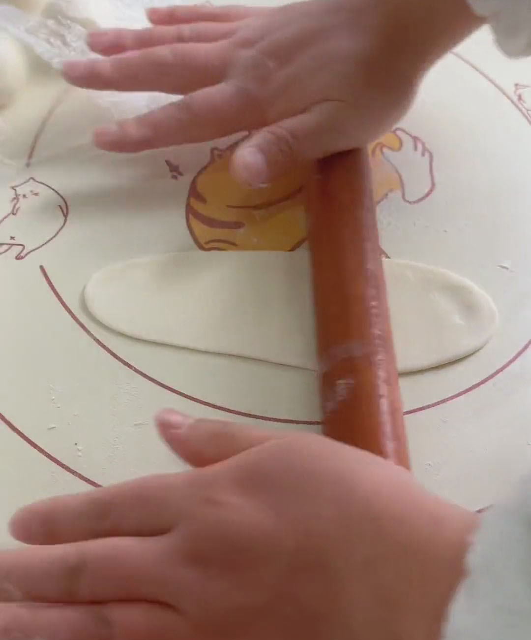 Take one wrapped dough ball and roll it into a long, tongue shaped oval