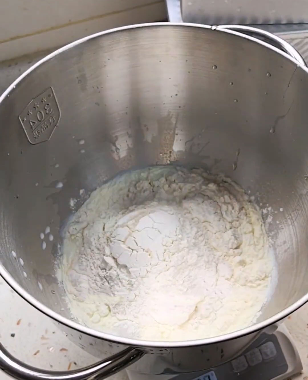 Add the bread flour, eggs, milk, sugar, salt, milk powder, and yeast to the stand mixer bowl in sequence