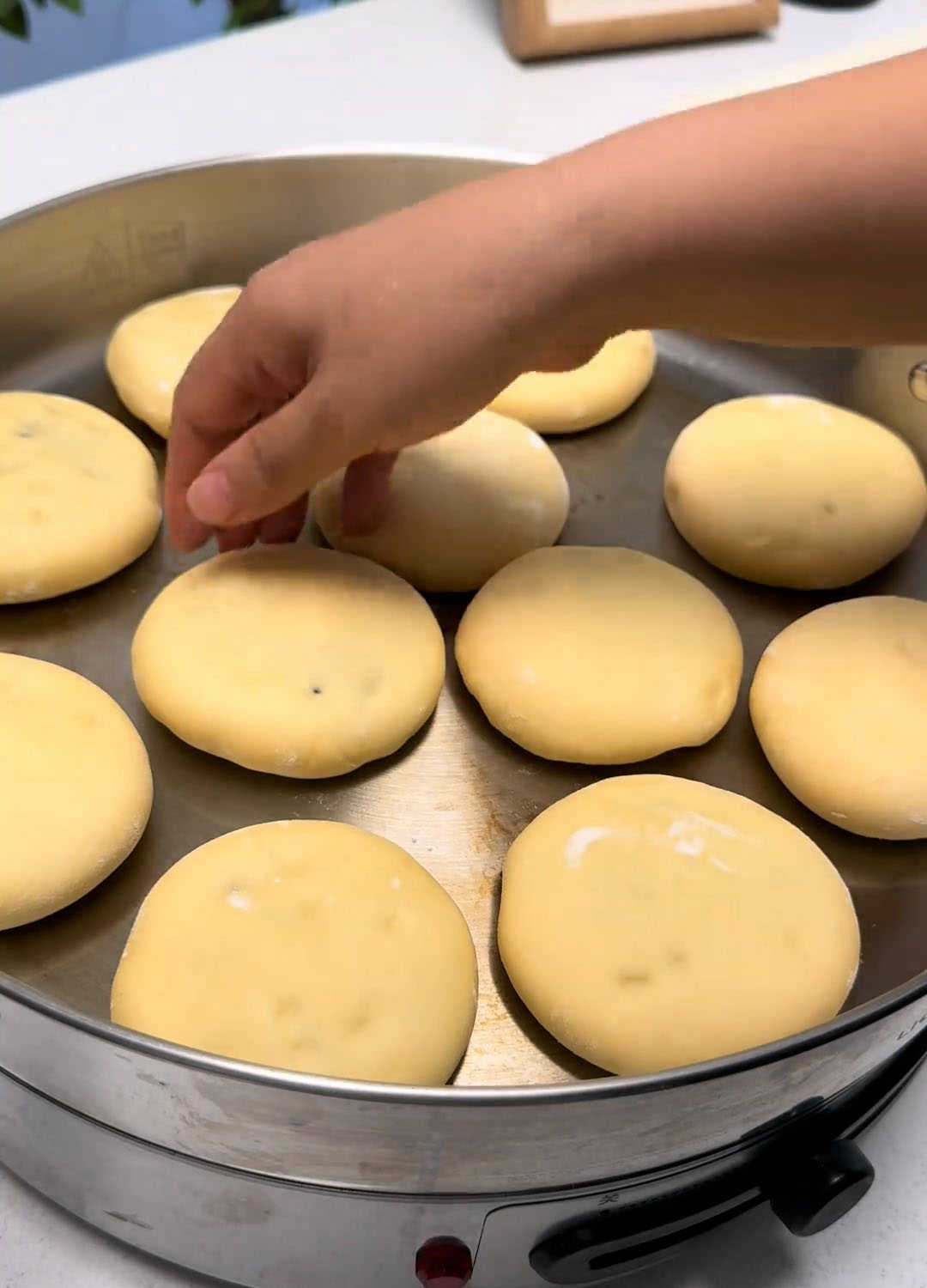 Arrange the risen buns in the pan
