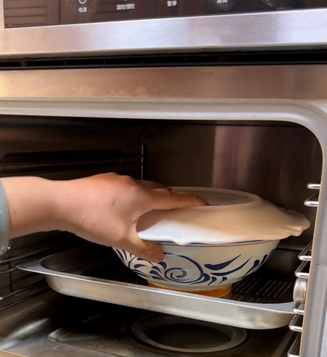 Cover the bowl tightly with a heatproof plate