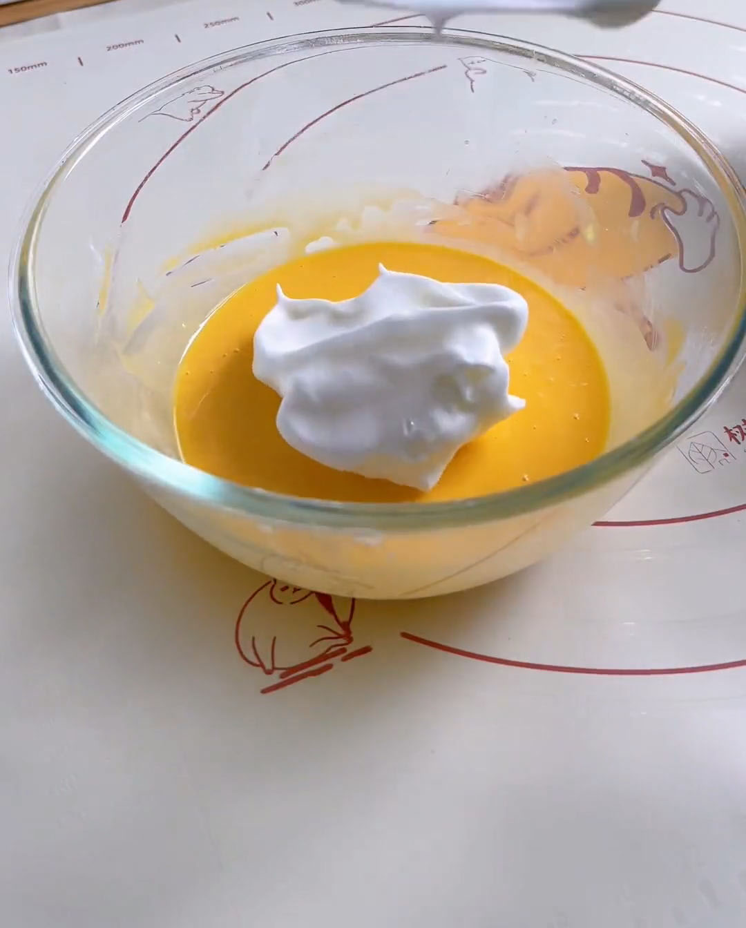 Fold one third of the meringue into the egg yolk batter