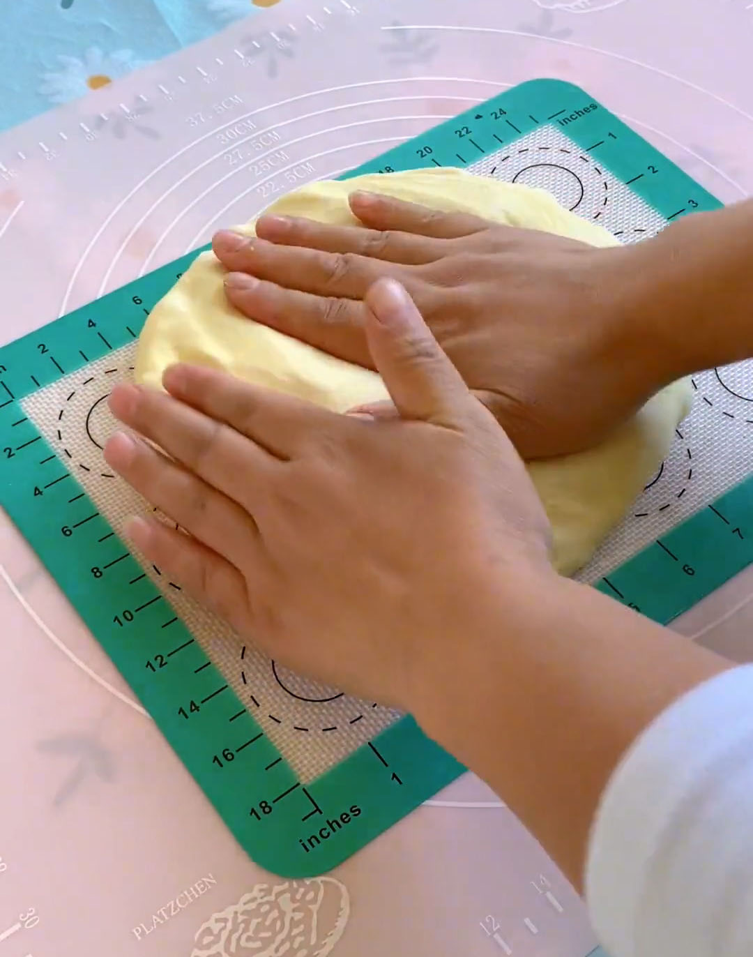 Gently press the dough with your palm to release excess gas