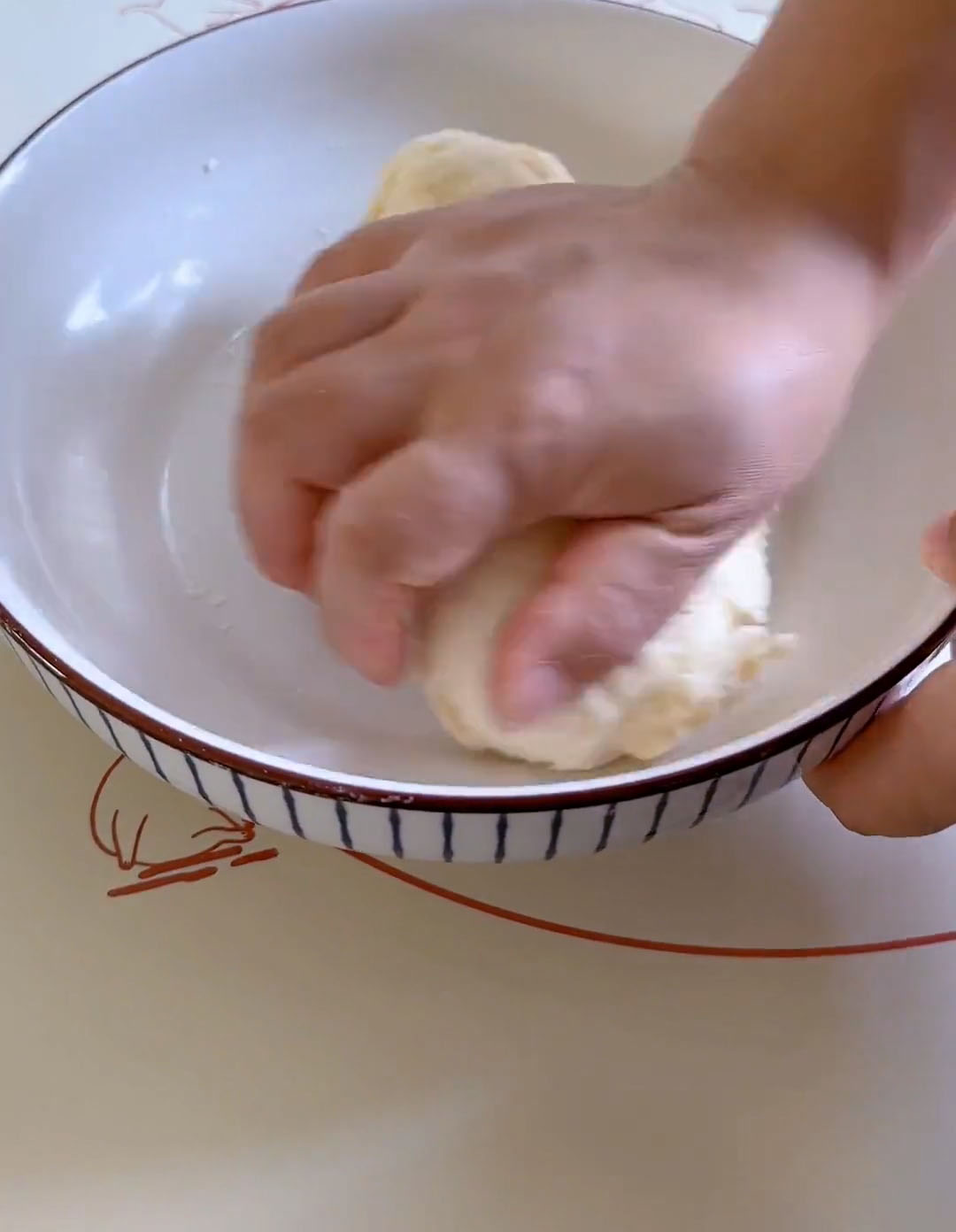 Knead the dough by hand until it forms a ball