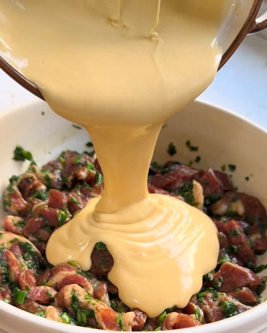 Pour the prepared batter over the marinated pork