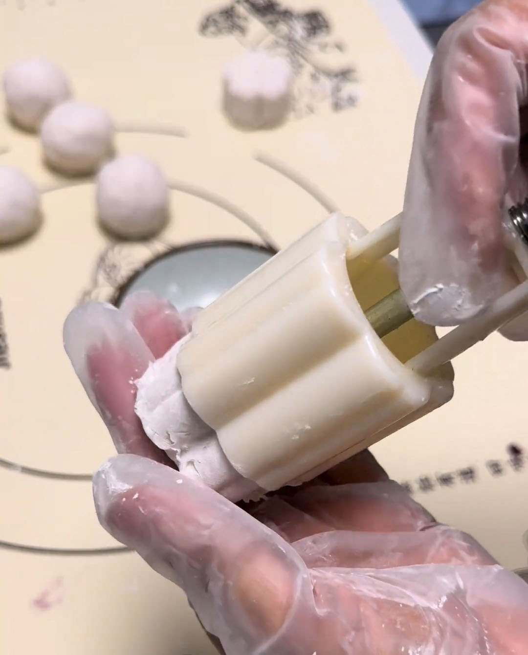 Press the ball into a lightly dusted mooncake or dim sum mold Press the ball into a lightly dusted mooncake or dim sum mold