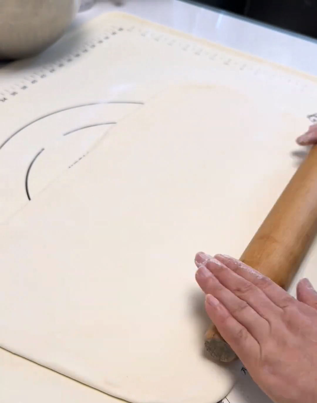 Roll the dough into a wide, thin sheet once more