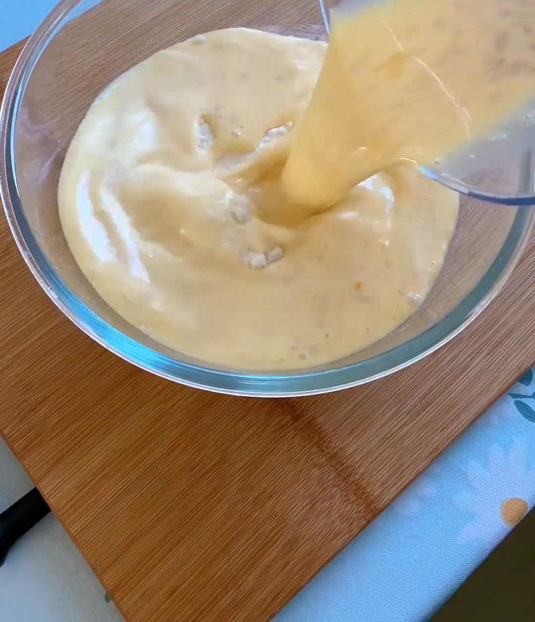 Slowly pour the liquid mixture into the bread flour