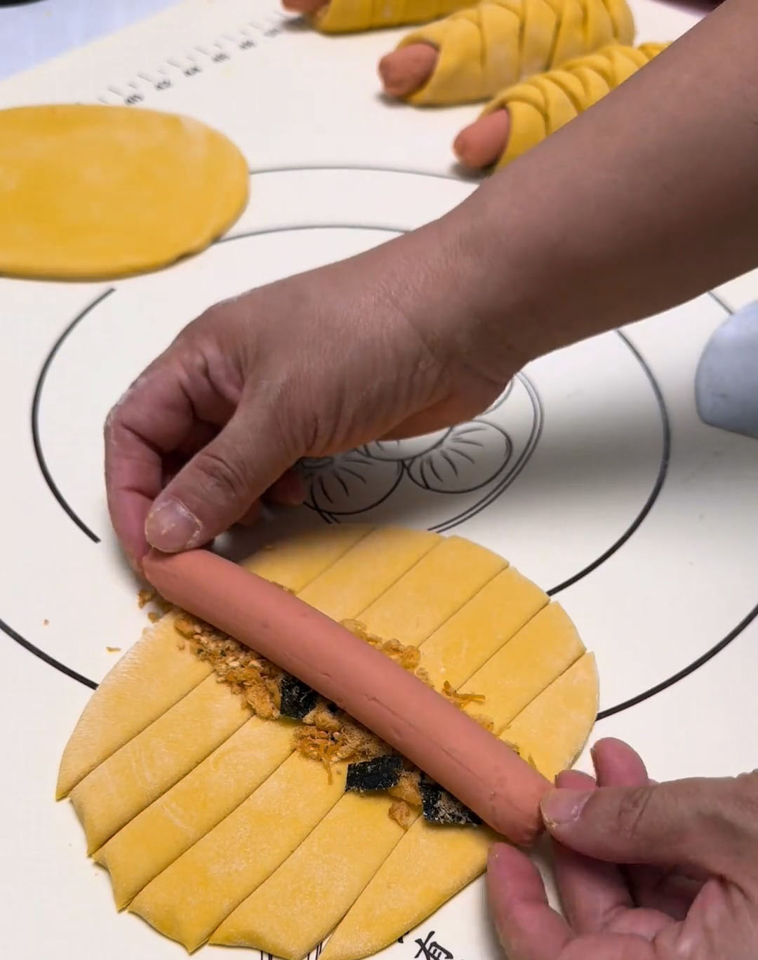 Sprinkle pork floss on top if using, then place one hot dog in the center Sprinkle pork floss on top if using, then place one hot dog in the center