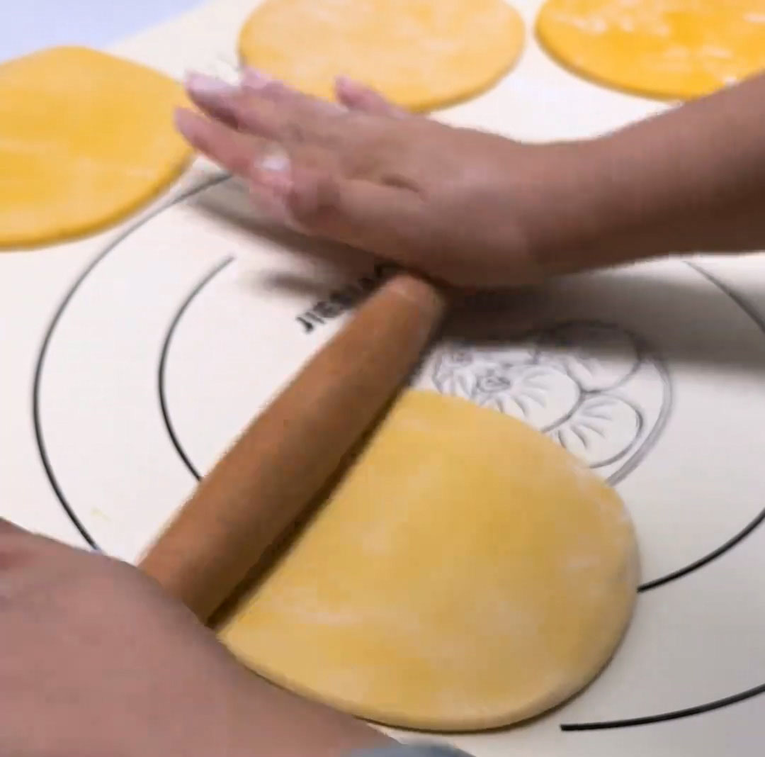 Take one portion, round it, and roll it into an oval sheet Take one portion, round it, and roll it into an oval sheet