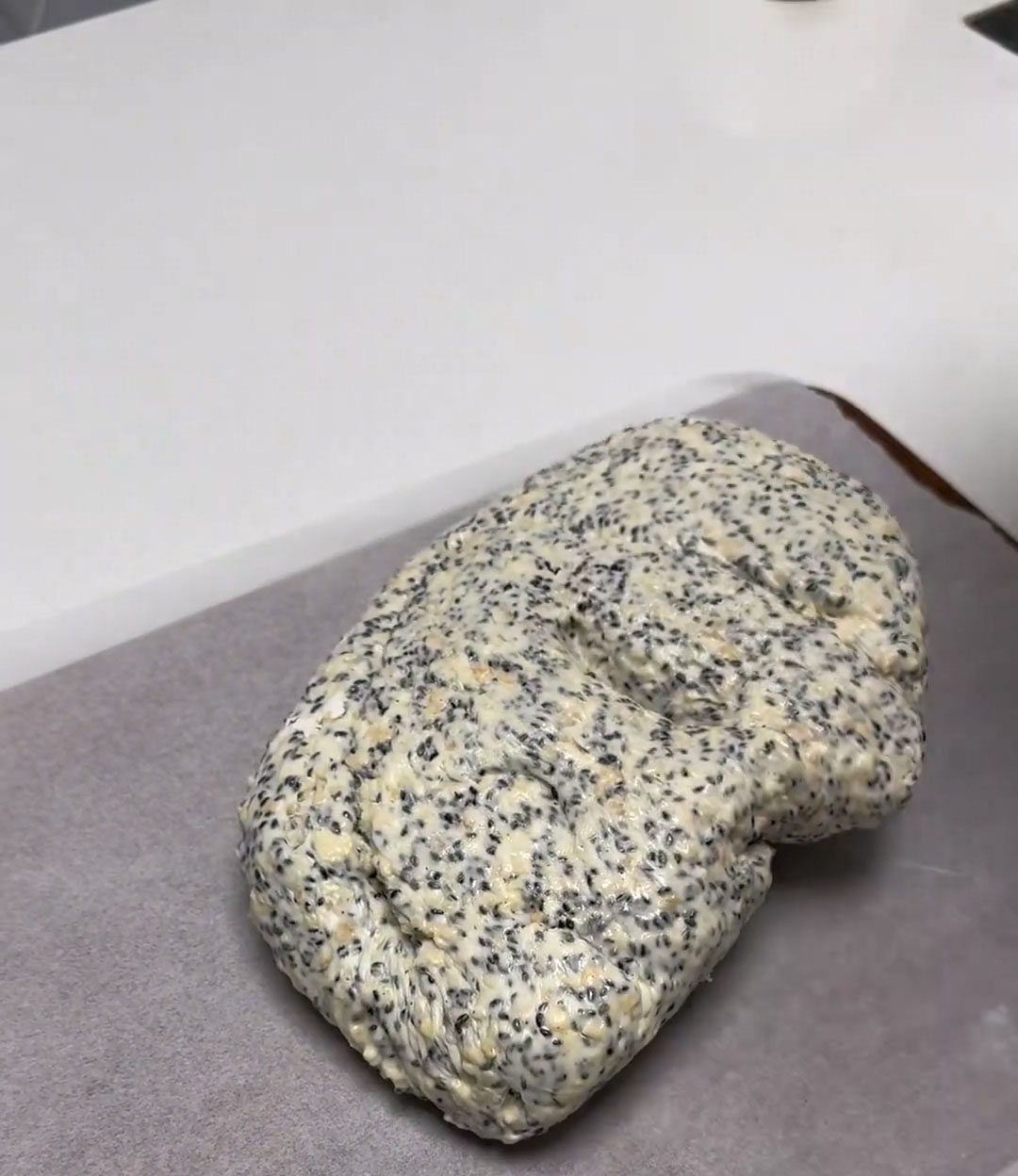 Transfer the hot nougat onto a work surface lined with parchment paper