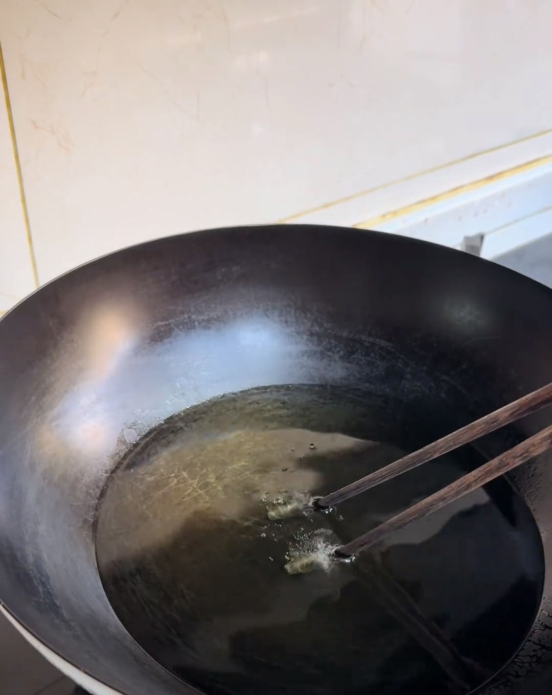 insert a wooden chopstick; small bubbles should quickly form around it