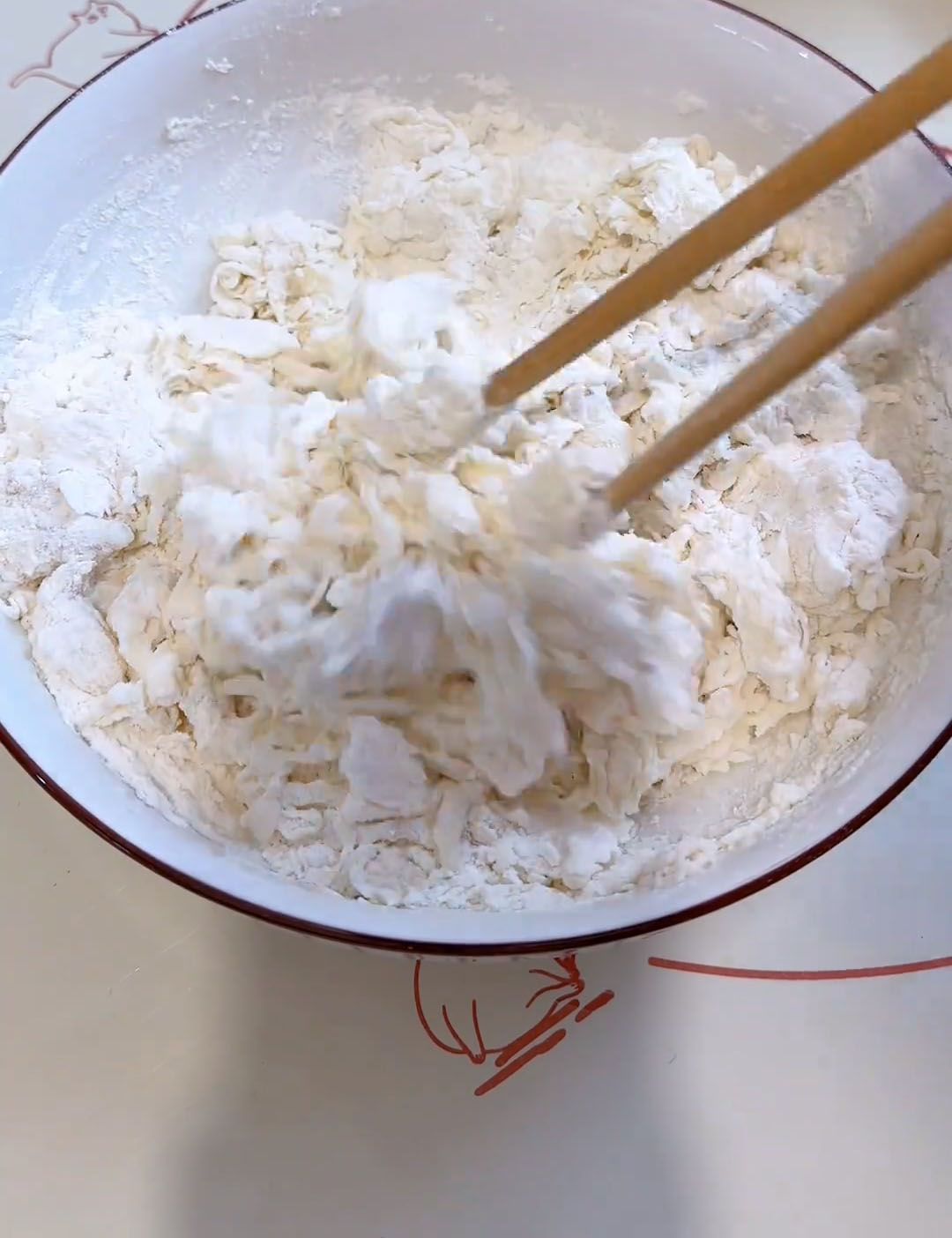 stir with chopsticks until a coarse, sticky dough forms with no dry flour left