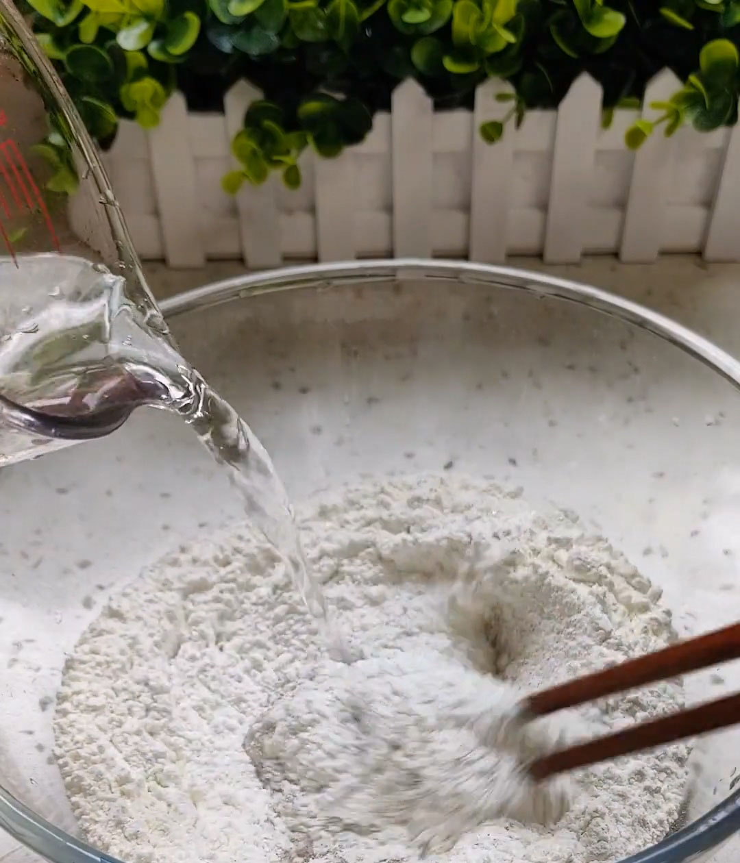 Use chopsticks or a fork to stir until a shaggy dough forms with no dry flour remaining