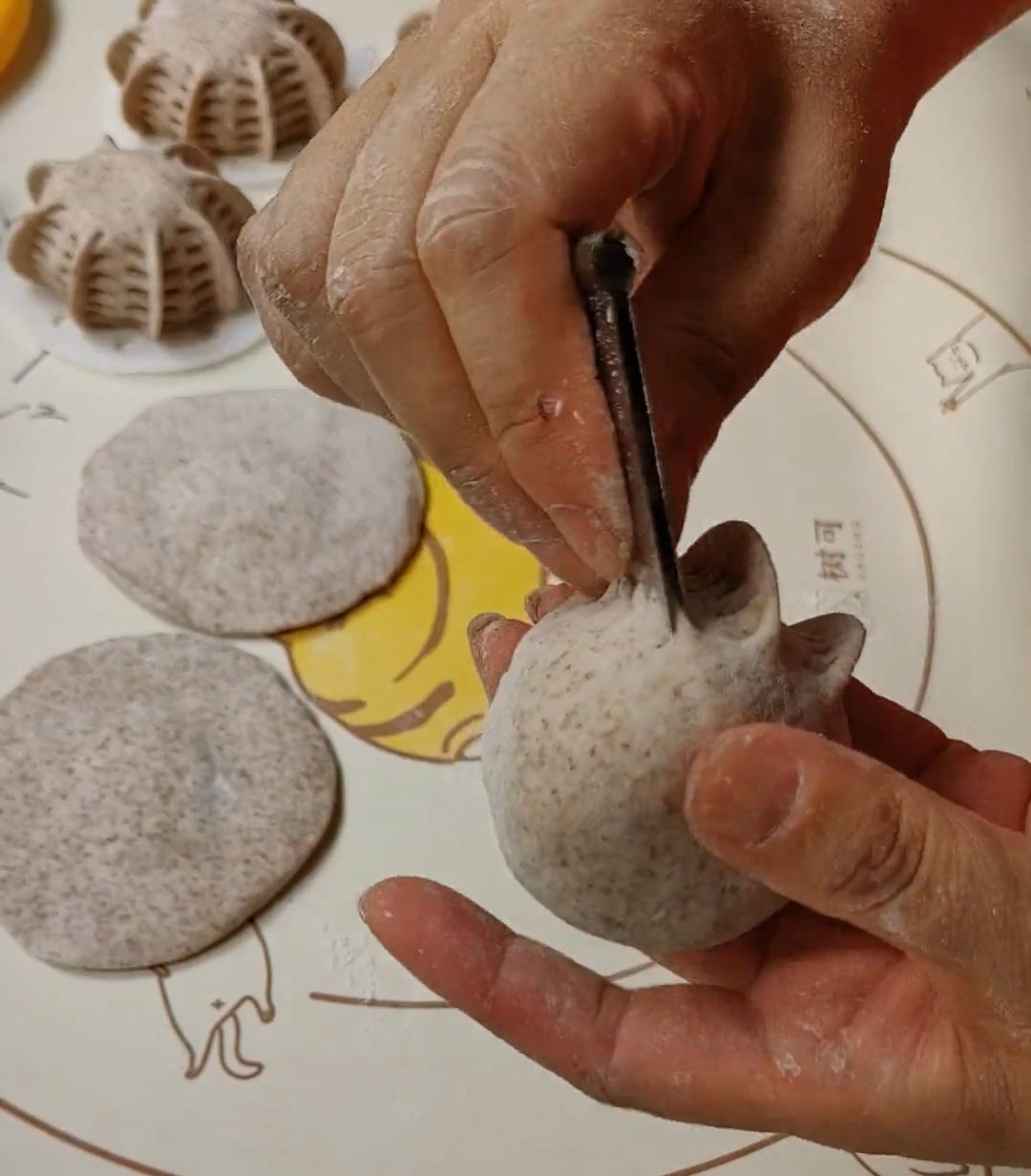 press the bun with a round mold to create a decorative pattern