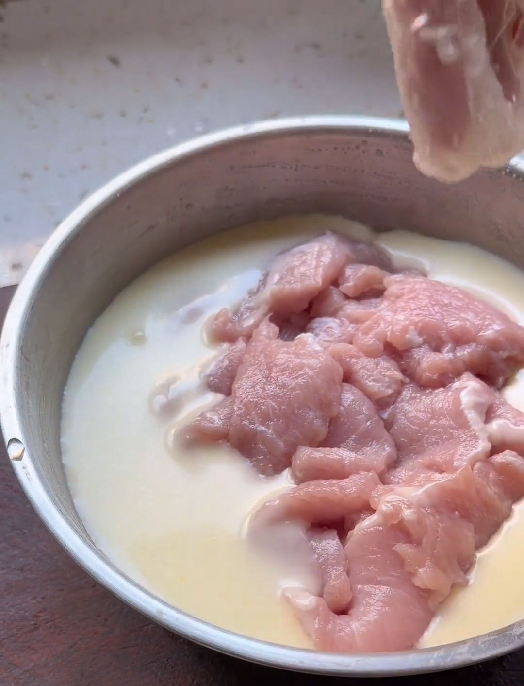 Add the marinated pork slices to the batter